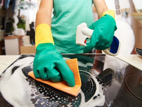 Clean kitchen surfaces as part of domestic cleaning